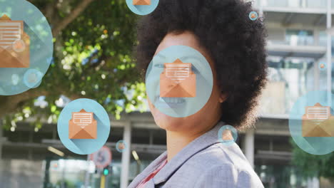 animation of letter on envelope in circles over smiling biracial woman walking on street