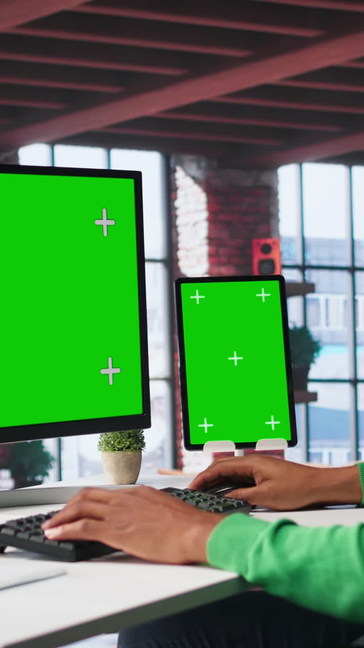 Vertical Video African american person using an isolated display on computer at home