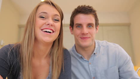 couple talking and laughing to video chat
