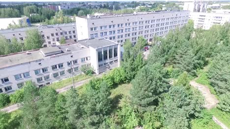 aerial view of an abandoned hospital in a city