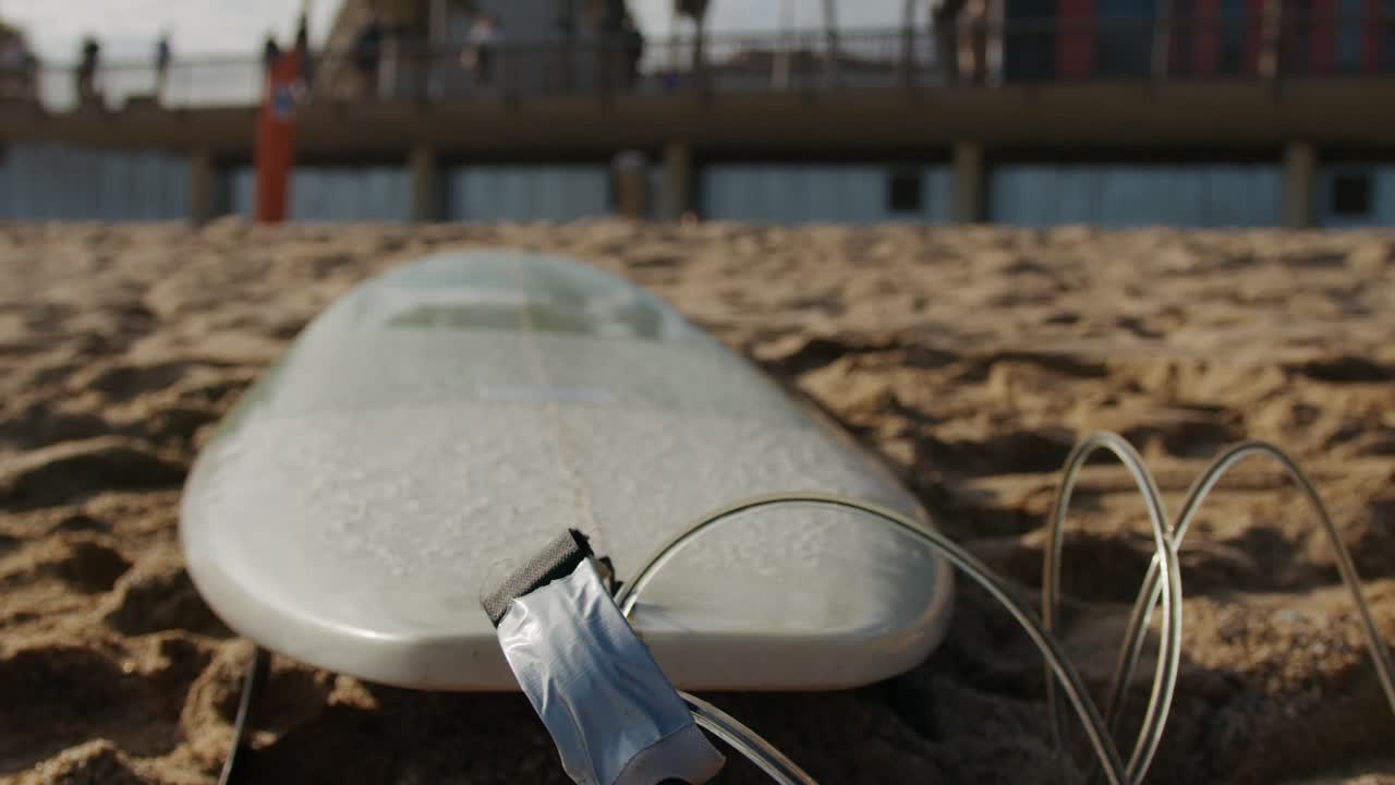 Surfer man walking to the beach at sunset preparing for surfing training and search for waves in Barcelona, spain, water, ocean exercise in sea with board, athletic male holiday or travel in vacation