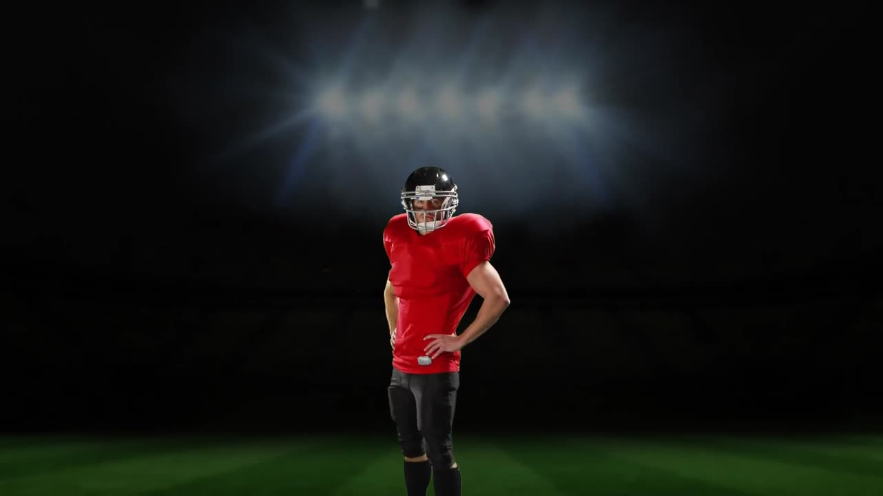 스포츠 경기장 앞에 서 있는 프로 미식축구 선수