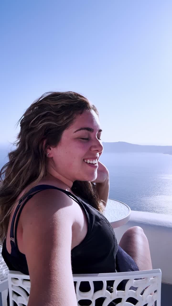 Young woman enjoying her vacation in santorini