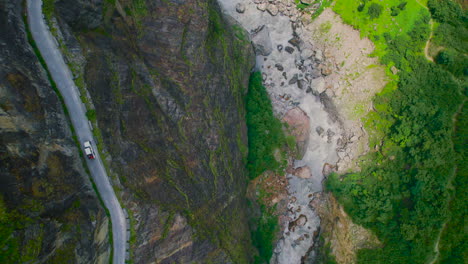 thrilling drone shot of a 4x4 jeep car on a dangerous road in manang, nepal