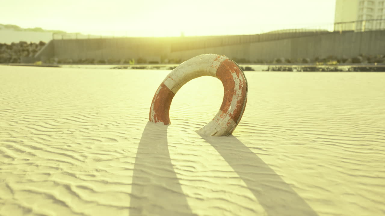 Sun kissed lifebuoy casting shadows on serene golden sands at sunset