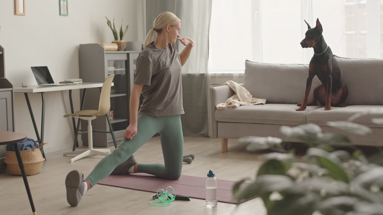 Blonde Woman Stretching and Dog Watching