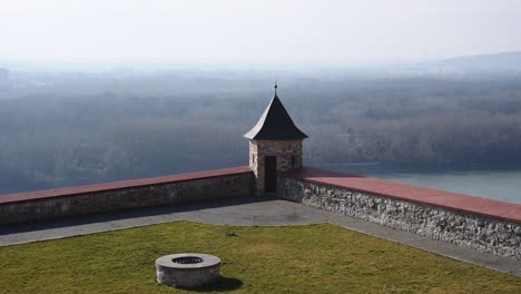 stone turret overlooking misty forest and danube river from bratislava castle , slovakia