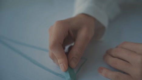 Close-Up-Of-Hands-Drawing-Straight-Lines-And-Triangles