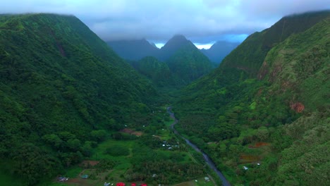 Vallee de Tautira Bay River village Tahiti island French Polynesia aerial drone cloudy morning sunrise towering jagged mountain peaks valley Teahupoo Mont Rauiri Aorai Taiarapu Taravao forward pan up