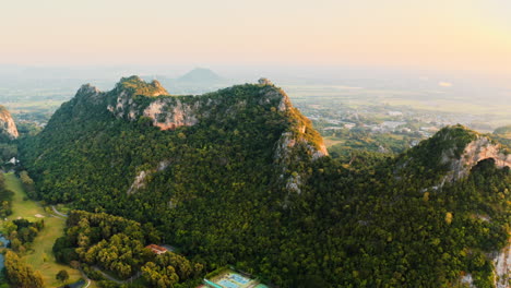 mountainous landscape with golf course and cityscape in the distance