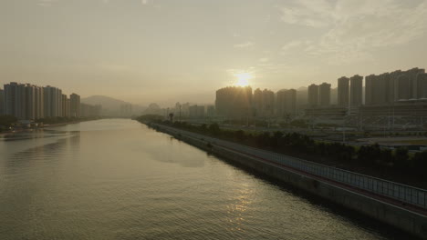 hong-kong-aerial-cityscape-at-sunset-of-skyscraper-building-with-river,-asia-china-drone-fly-above-main-metropolitan-area