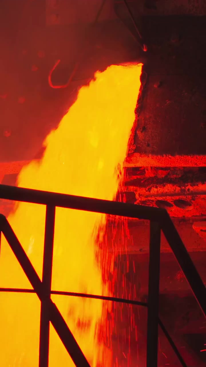 Molten Cascade Flowing Past Platform And Stairs With Silhouette Of Rail And Catwalk, Bright Orange Flow