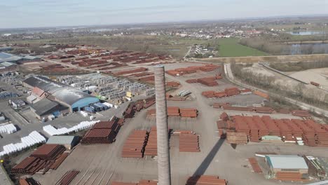 Jib-up-of-old-smoke-stack-overlooking-large-industrial-junk-yard