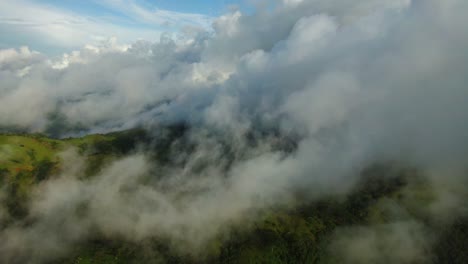 low tropical fog hangs across lush fertile rainforest mountains, guanacaste, costa rica, aerial