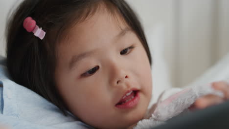 cute-little-asian-girl-using-tablet-computer-with-family-enjoying-playing-games-on-touchscreen-device-relaxing-at-home-together-4k