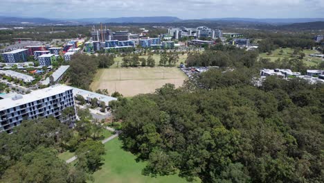 musgrave sports park with open fields and trees in southport, queensland, australia. aerial drone shot