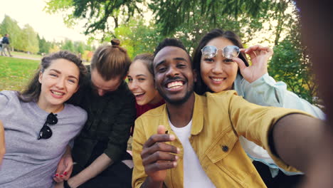 friends taking selfie in park