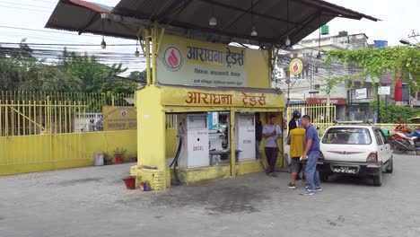 petrol station - driver refuels his car at a local gasoline station in kathmandu, nepal. - wide shot