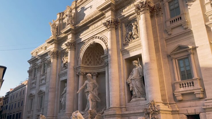 A Sunlight Striking At The Baroque Exterior Of Trevi Fountain In Rome, Italy