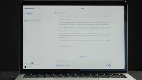 laptop displaying deepseek chat application with code and conversation