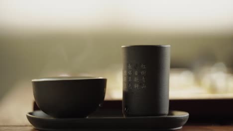 chinese tea set and glass chinese chess on the golden chess board