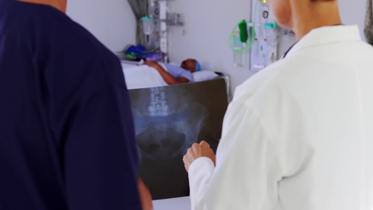 doctor and nurse discussing over x-ray report 4k