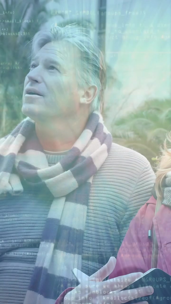 Vertical video: Man lowering device and looking up to share view with woman, tech overlay rising