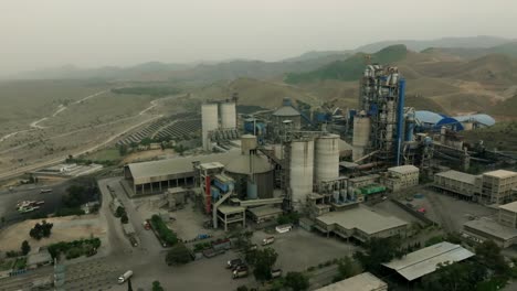aerial view of a cement factory in karachi, pakistan, showing the industrial landscape and environmental impact