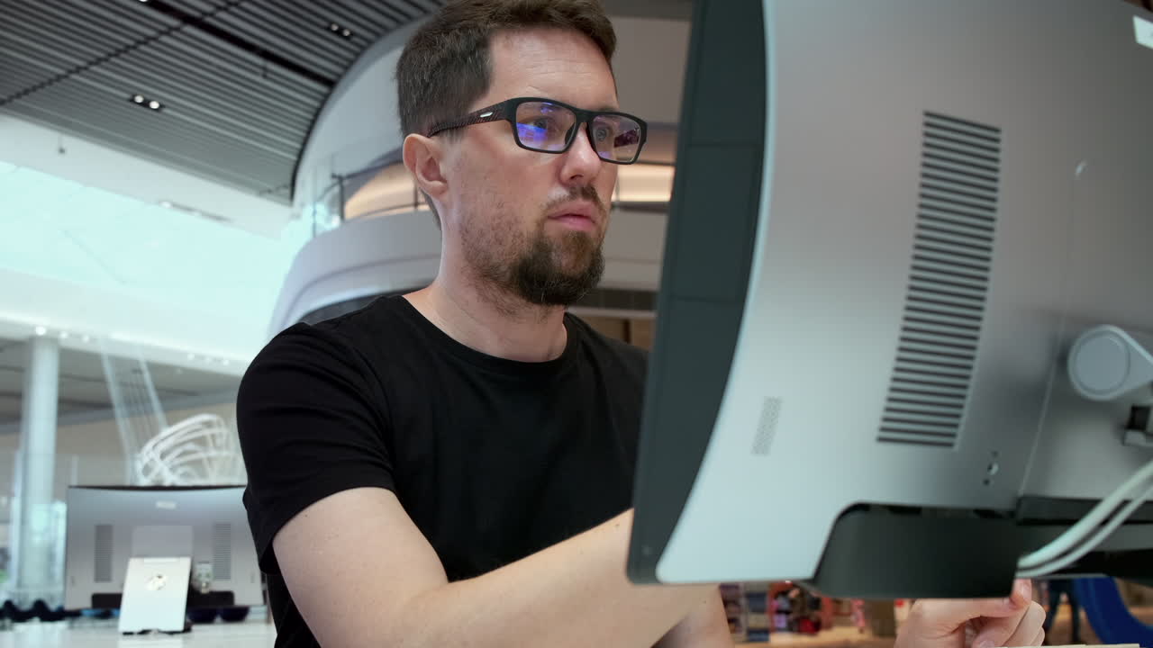 Man working on computer in a modern library