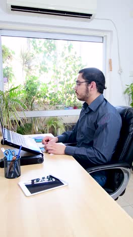 man performing exercises and stretching in front of a laptop. working at home, health concept.