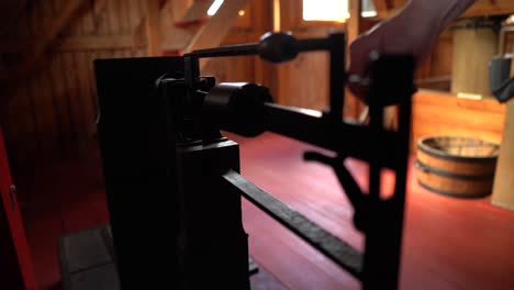 hand of caucasian male moving weights on large vintage scales