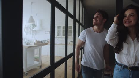 portrait of young couple entering home. happy family moving new house.