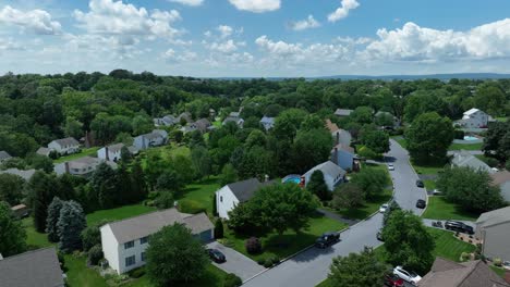 aerial view over scenic american neighborhood with garage and swimming pool in garden