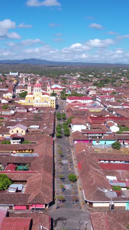 vertical drone shot of granada, nicaragua. pedestrian street, cathedral and old colonial buildings