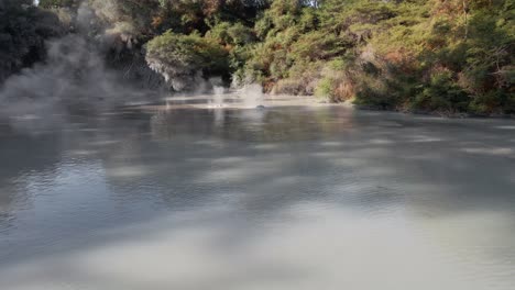 low aerial fly-over shot of the steaming hot mud pools of waiotapu in slow motion