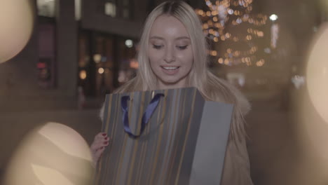 young woman given present and is extremely happy to receive it - in slow motion and ungraded