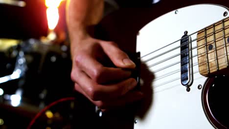 Close-up-of-man-playing-electric-guitar