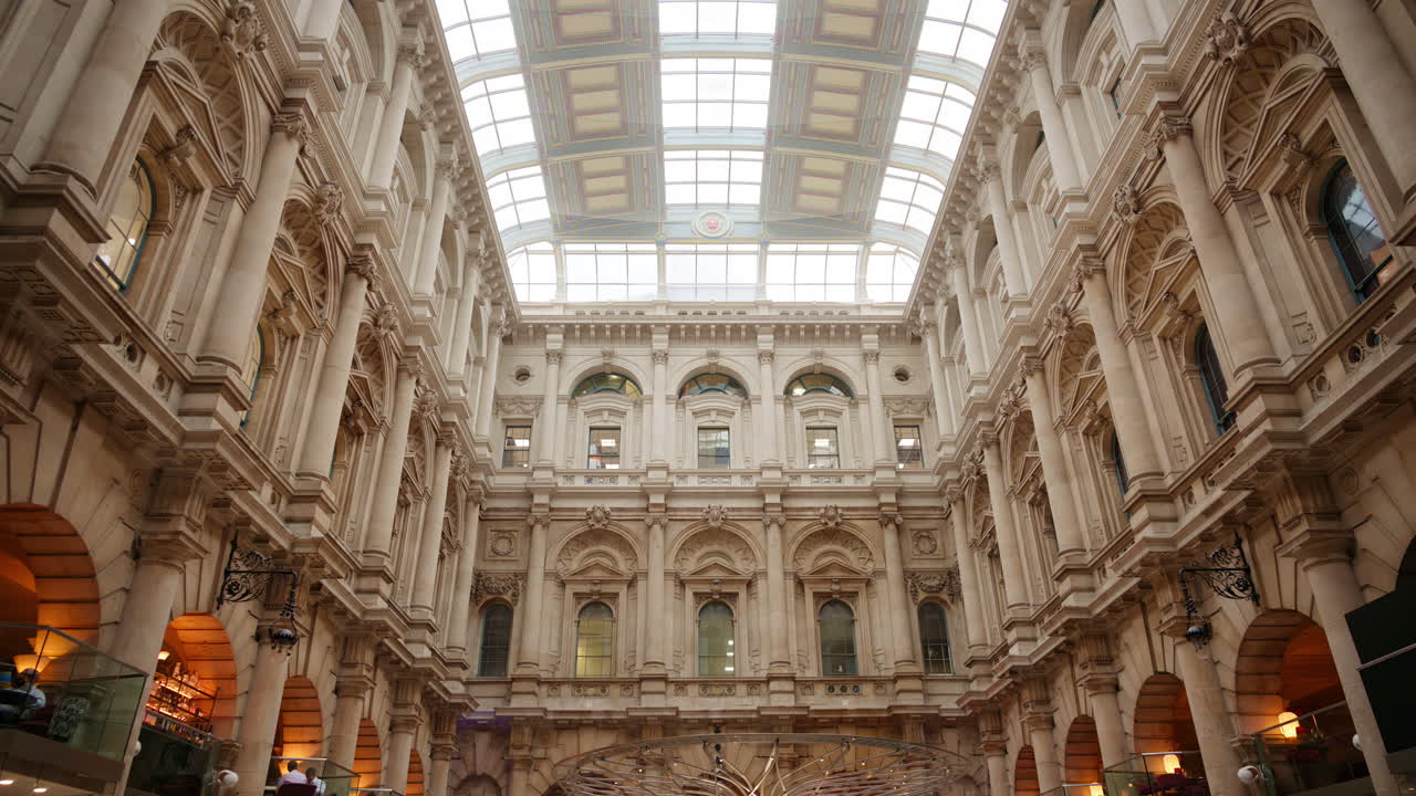 The Interior of the Royal Exchange building with arched windows and glass roof in London, England