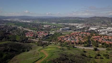 Aerial-views-of-freeways-and-suburban-sprawl-near-green-foothills