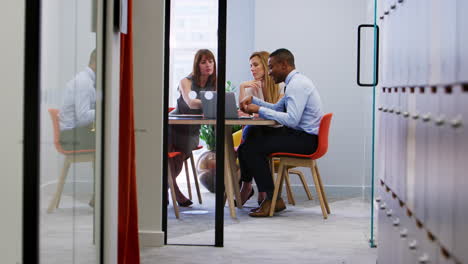 three business colleagues at an informal office meeting