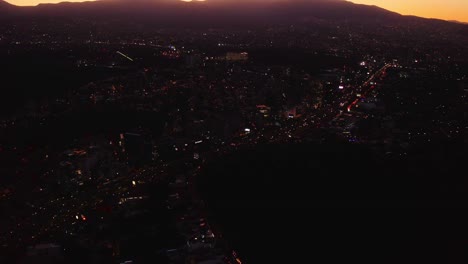 cielos rosados al amanecer sobre una carretera oscura y transitada con tráfico en la ciudad de méxico, por la noche