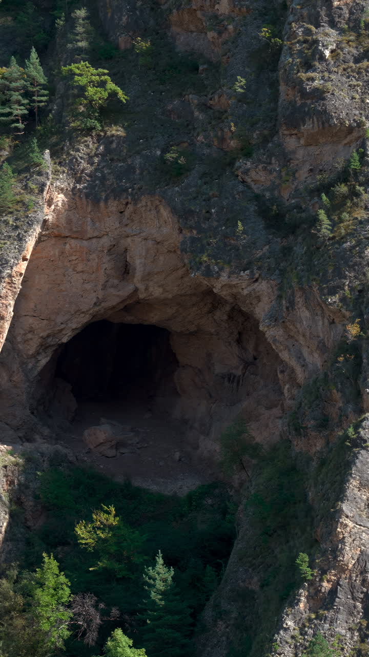 Aerial Drone View Cliff Cave Entrance. Majestic Sandstone Arch Leading Into Dark Cavern, Surrounded By Dense. Creative