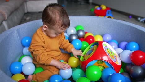 baby playing in a ball pit