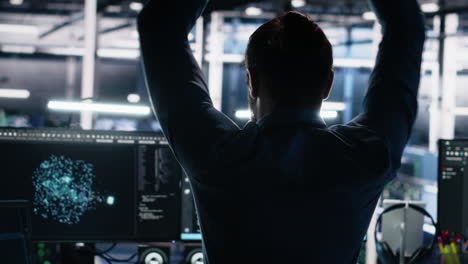server room technician stretching sore back while using ai at desk