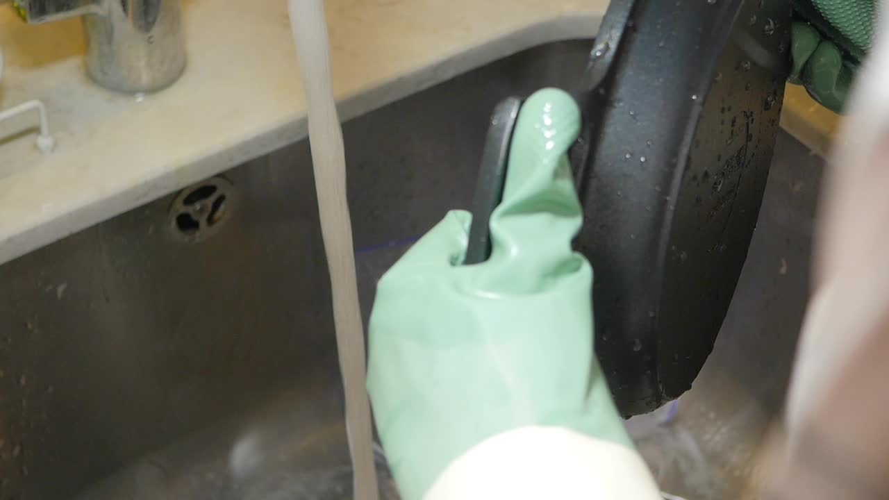 Washing a pan in the sink