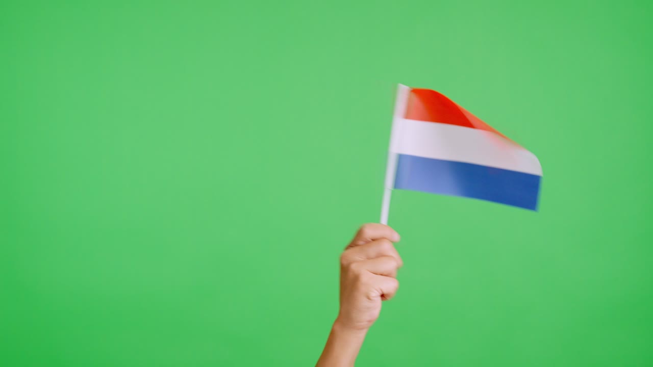 Hand waving a pennant of a dutch national flag