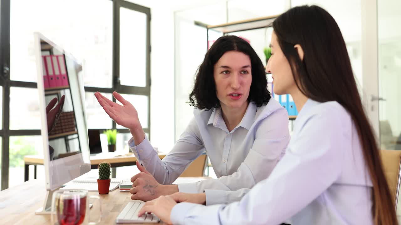 Two colleagues working together in an office