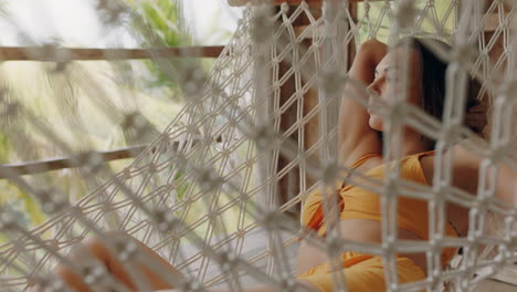 attractive-woman-in-hammock-enjoying-comfortable-lifestyle-on-vacation-in-holiday-resort-swaying-peacefully-on-lazy-summer-day-in-tropical-paradise-cabin