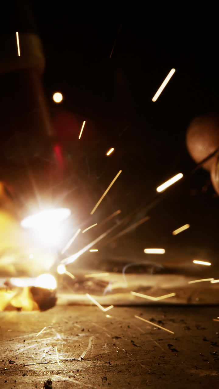 Close-up of welder using welding torch