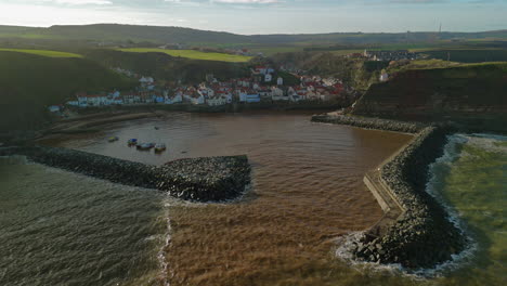 pullback establishing drone shot of staithes coastal village yorkshire